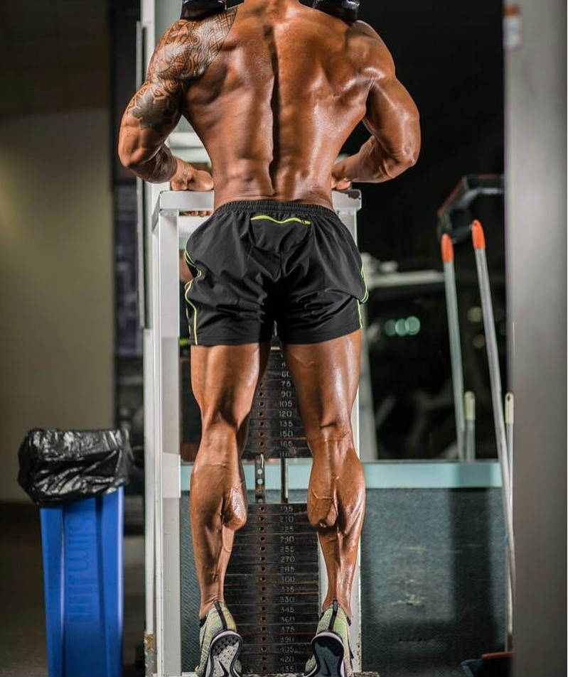 Jake Alvarez completing a calf raise and shoing his well build back and legs