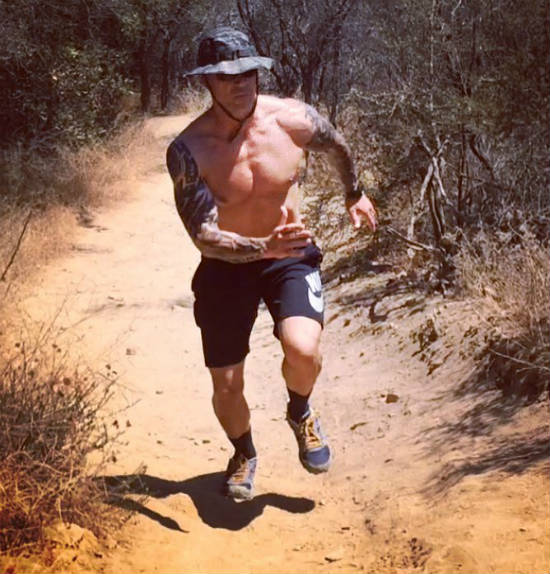 Jason Ferruggia completing a trail run, showing his large chest and legs