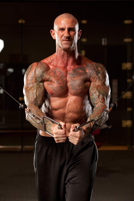 Jim Stoppani shirtless, doing cable crossovers