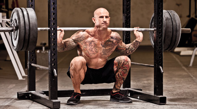 Shirtless Jim Stoppani doing deep heavy squats