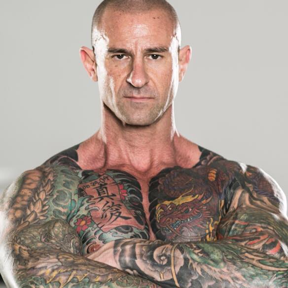 Jim Stoppani with his arms crossed, looking directly into the camera