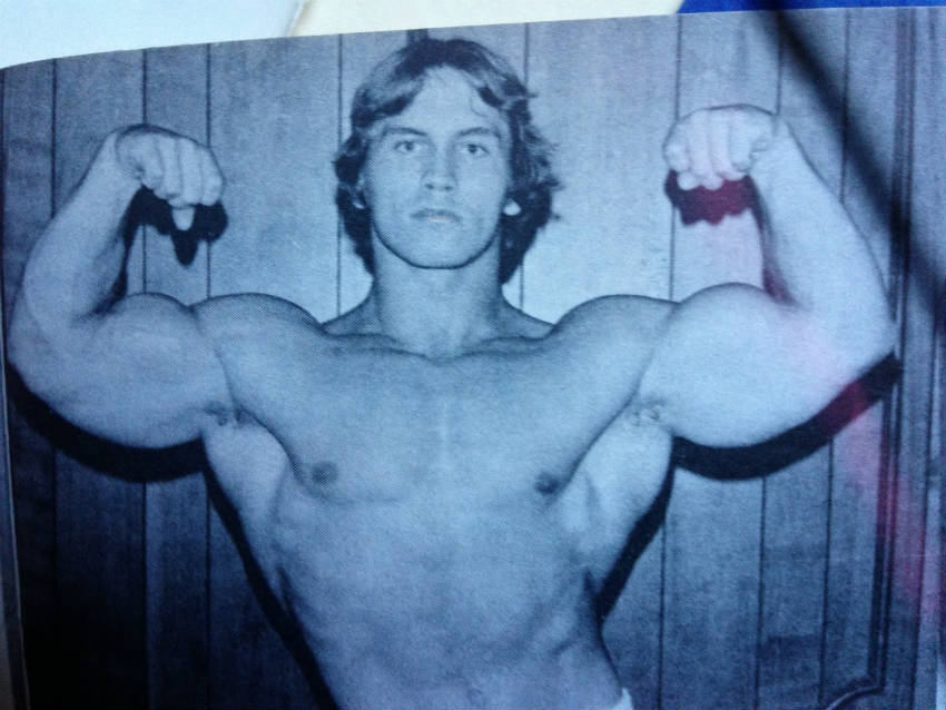 Lance Dreher flexing his arms in the 1970's, showing his large biceps