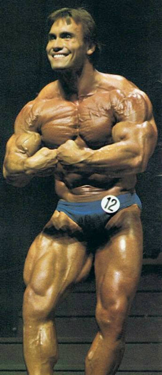 Lance Dreher posing at the 1983 Mr Olympia in Munich, showing his well built arms to the judges.