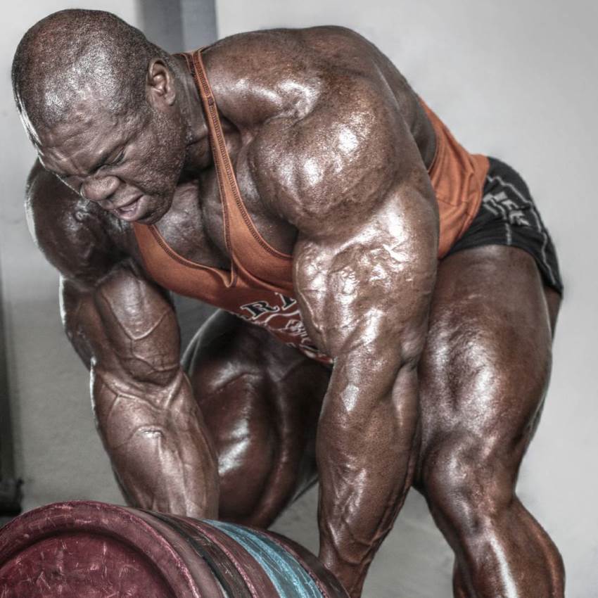 Lionel Beyeke doing heavy T-bar rows, with his arm and shoulder muscles pop out