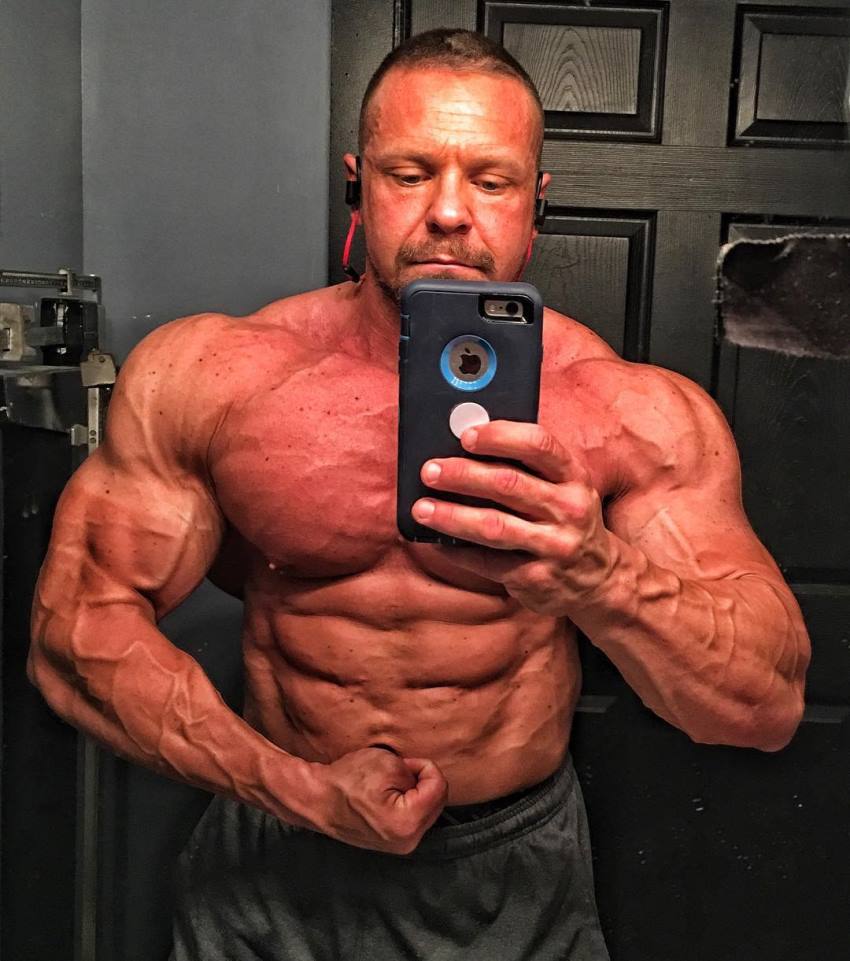 Marc Lobliner taking a shirtless selfie in the mirror, showing his ripped and huge body