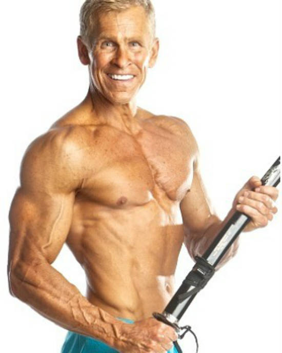 Mark Mcilyar holding a katana, showing his ripped abs, large chest and pumped delts