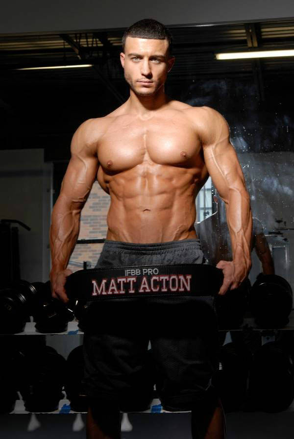 Matt Acton shows his ripped upper body while holding a weight lifting belt with his name on