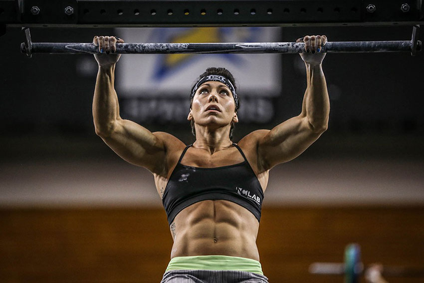 Miranda Oldroyd doing a pull up looking strong and lean with ripped abs 