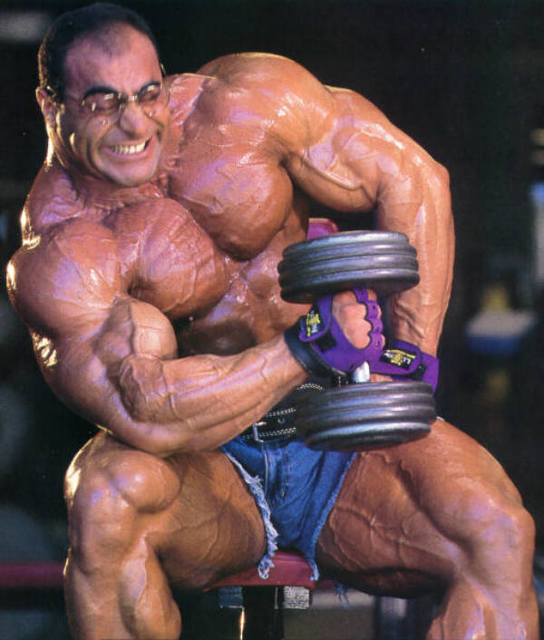Nasser El Sonbaty completing a bicep dumbbell curl, showing off his huge biceps and chest