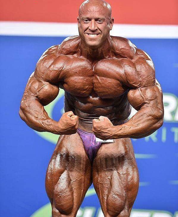 Petar Klancir on the stage, showing his most muscular pose to the auditorium