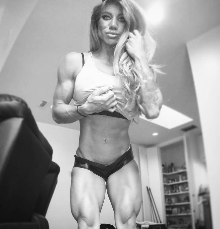 Rachelle Carter flexing her arms, abs, and legs for the camera, with one of her hands in her hair