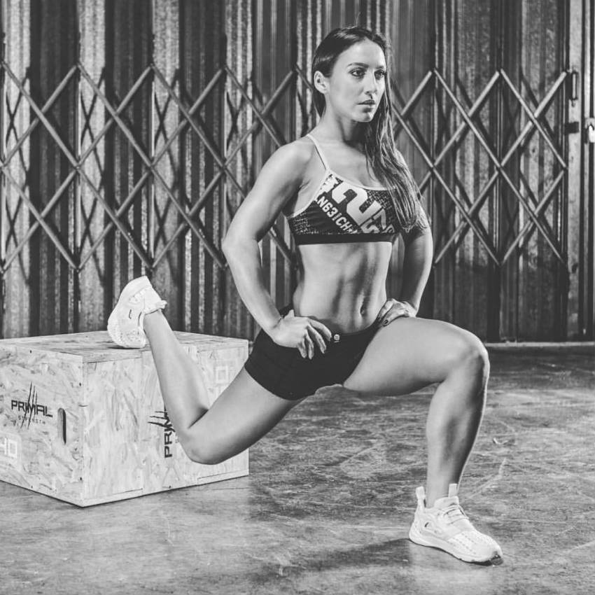 Sandra Radav completing a lunge with her trailing leg on a box, showing her calves