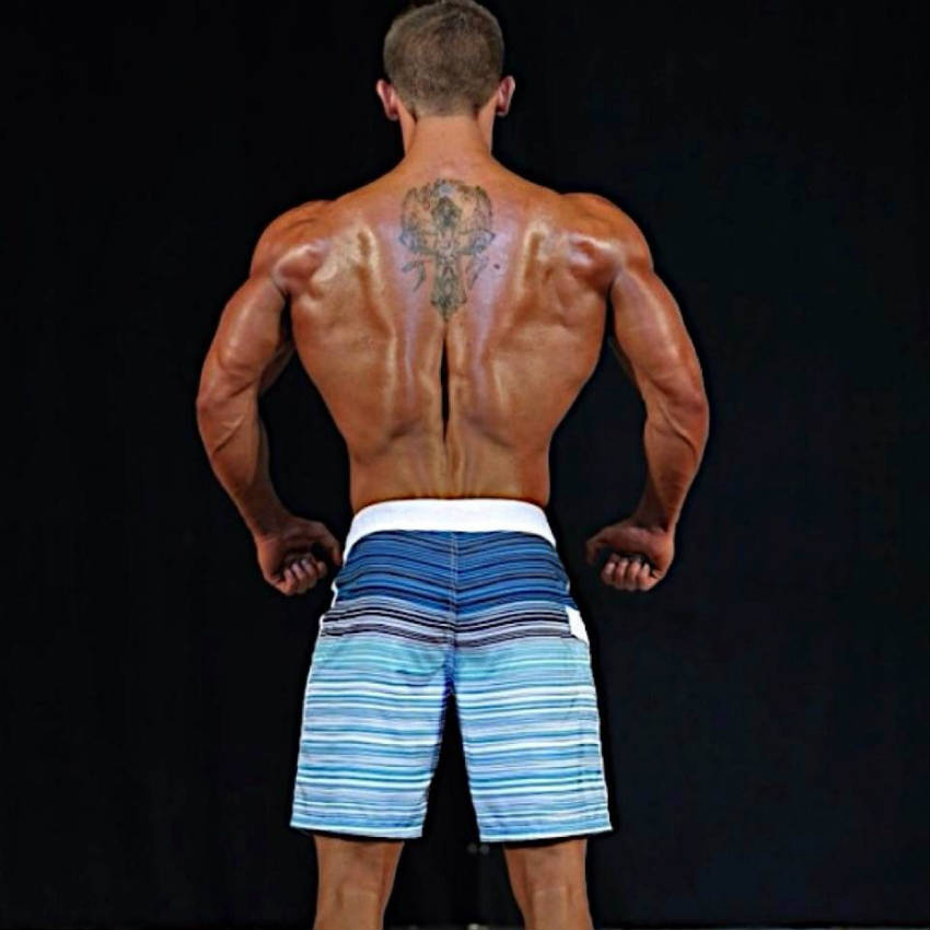 Tyler Stines shows his ripped back and toned triceps at a physique competition 