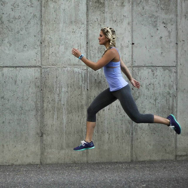 Whitney Simmons completing a jump in running gear, showing off her toned legs and arms