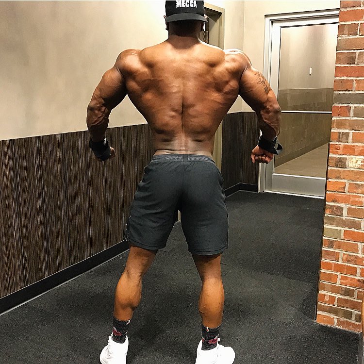 Brandon Hendrickson showing his ripped back, spreading his arms and lats