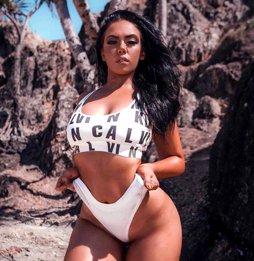 Lauryn Clare standing by the rocks near a beach, looking fit and healthy