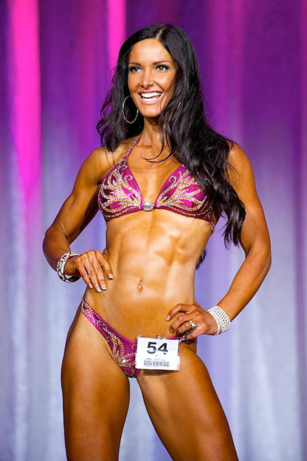 Lori Harder showing her toned abs and legs at a competition