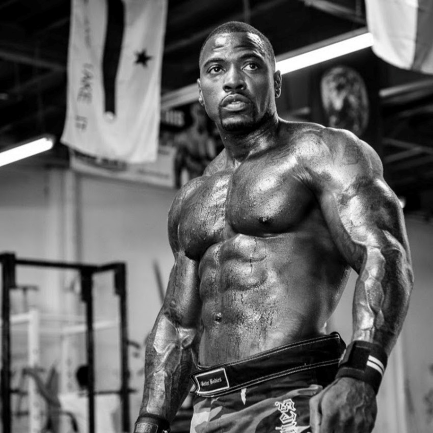 Mike Rashid in a gym, looking ripped and big shirtless