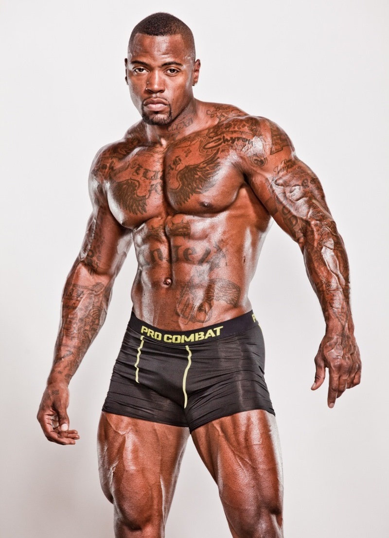 Mike Rashid doing a photoshoot, his tattooed body looking extremely lean and muscular