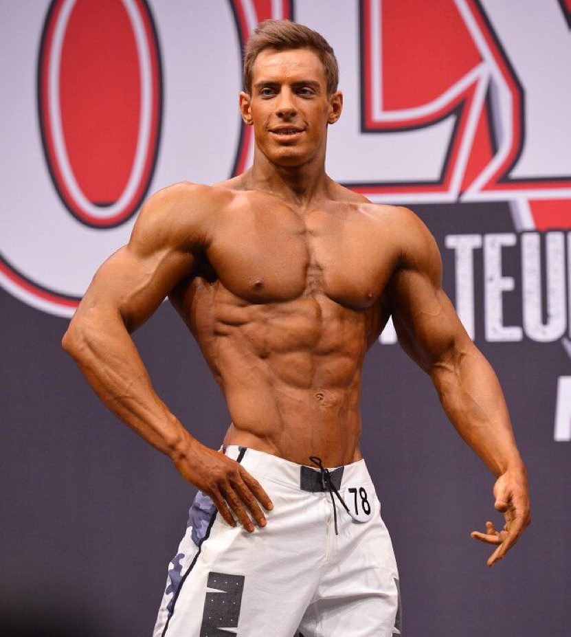 Nikolay Kuleshov on the Olympia stage, looking ripped and vascular