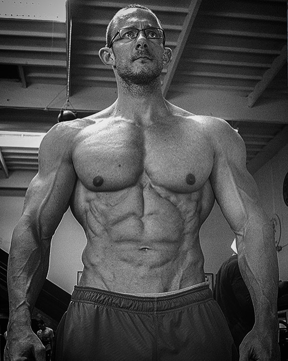 Black and white photo of Brandon Gerdes showcasting his ripped and muscular physique