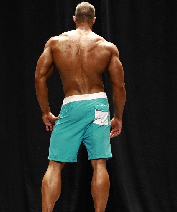 Coty Reutzel showing his back muscles to the judges on the bodybuilding stage