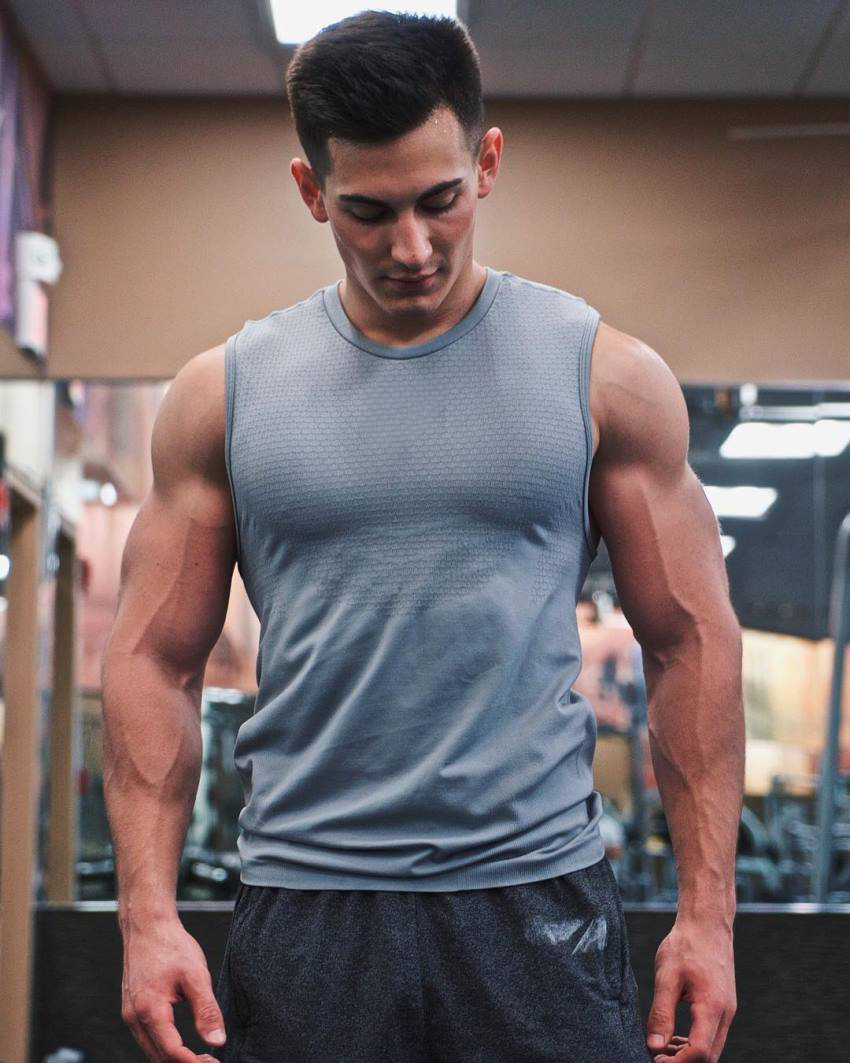 FaZe Censor in the gym in a grey sleeveless shirt, looking muscular and lean