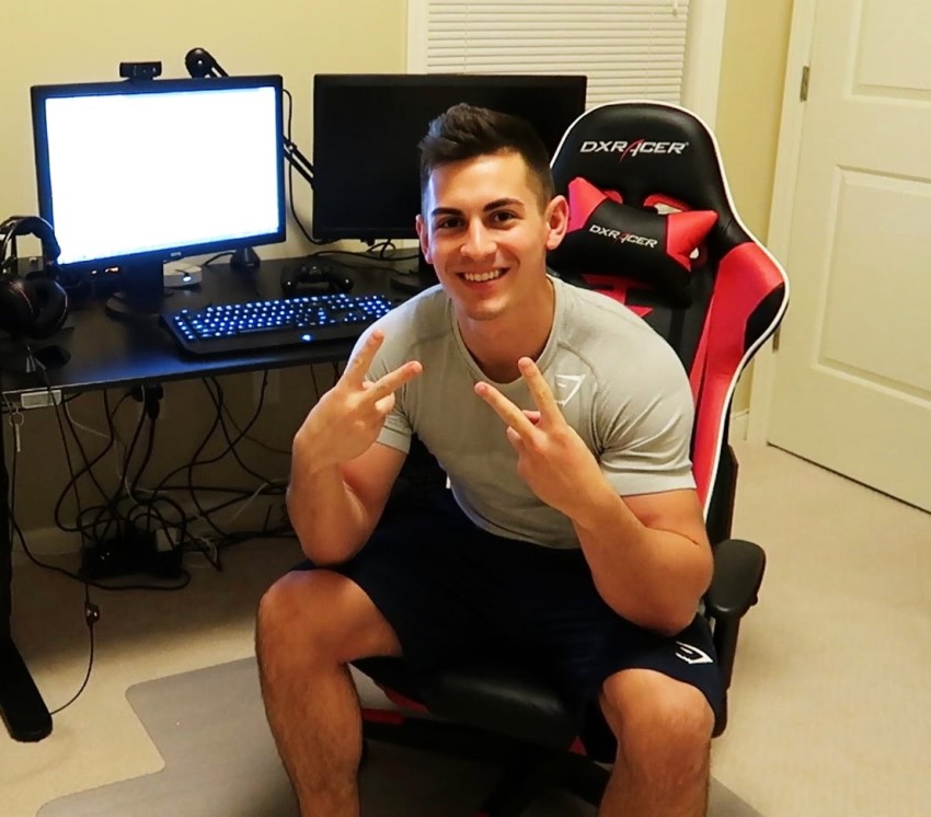 FaZe Censor in his gaming room, sitting by a computer and smiling at the camera
