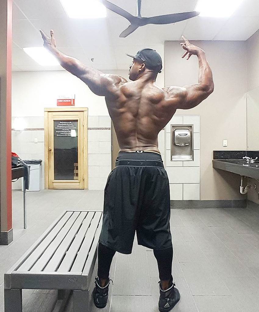 Jacques Lewis doing an old-school Frank Zane pose, showcasting his back, arms, and shoulders