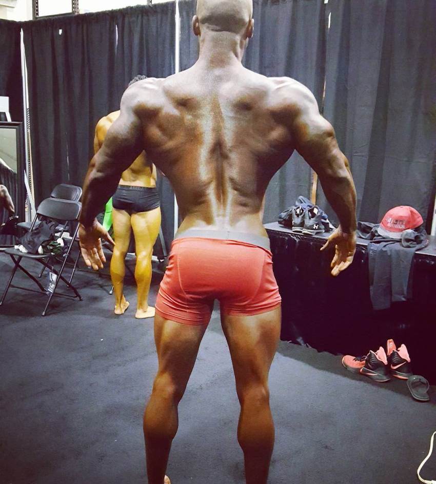 Jacques Lewis backstage, practicing his posing, showing his awesome back and legs