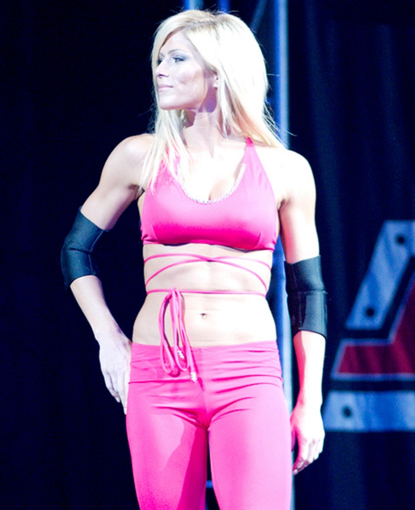 Torrie Wilson walking out on the big WWE stage, looking confidently at the public