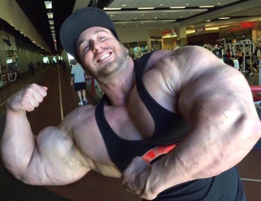 Craig Golias flexing his huge biceps