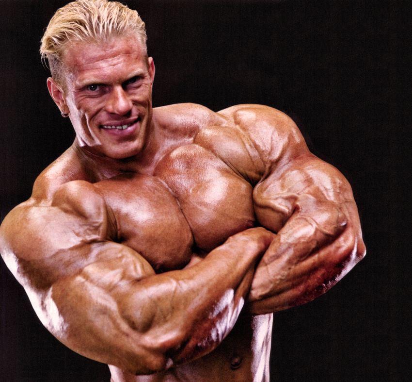 Dennis Wolf with his arms crossed, looking massive and muscular