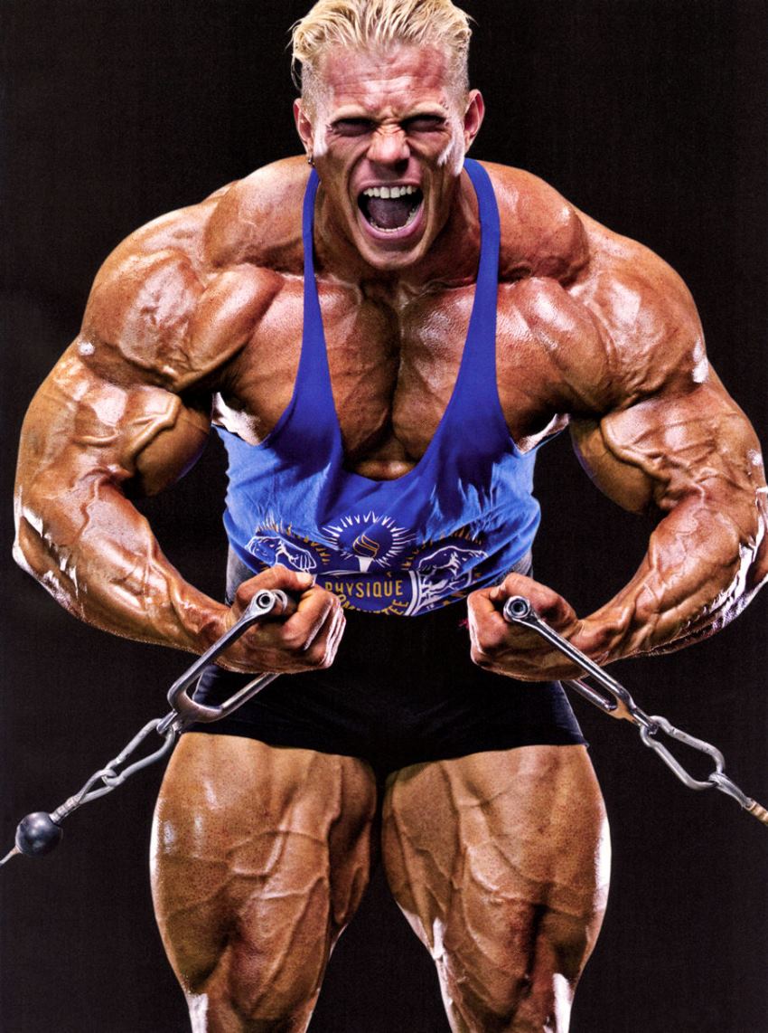 Dennis Wolf doing cable curls with a pained grimace