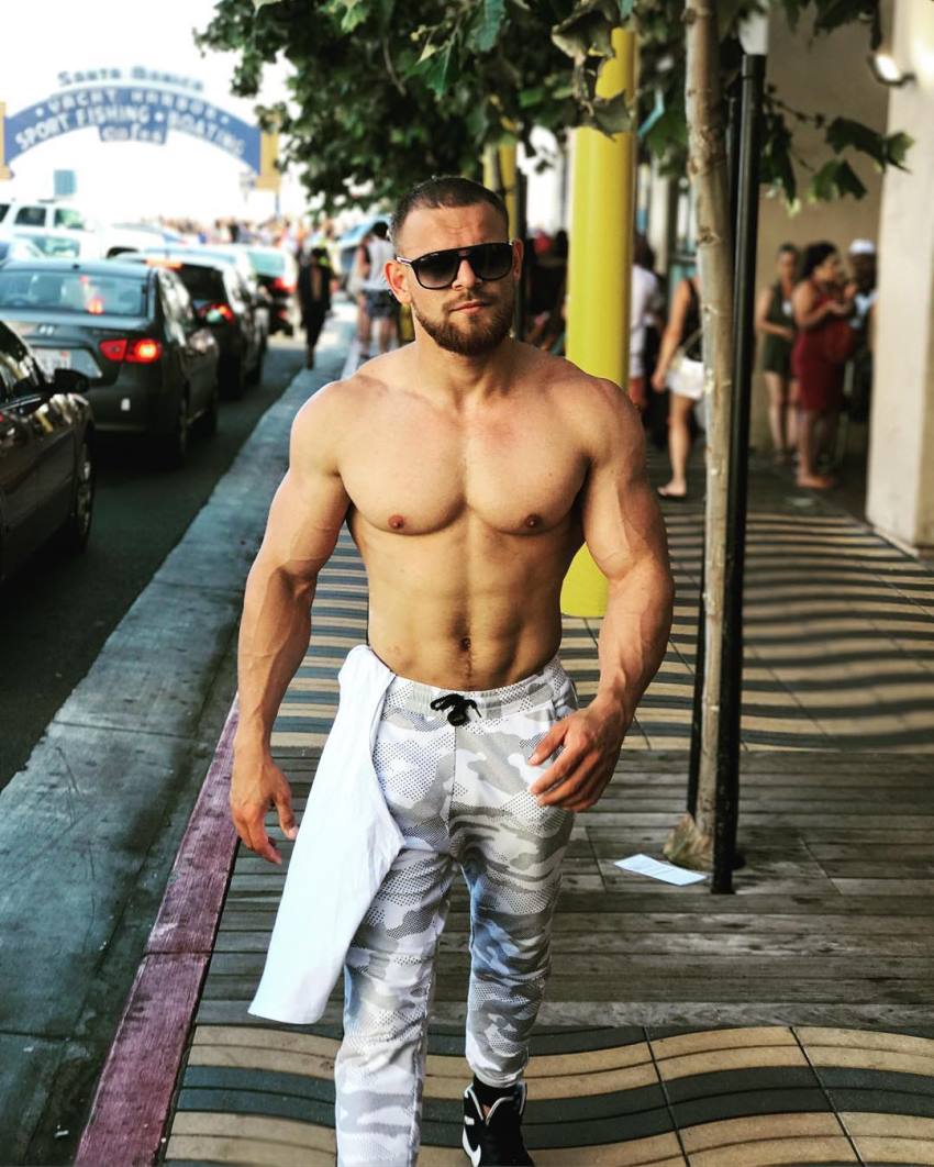 Islam Badurgov walking shirtless on the street, looking lean and aesthetic