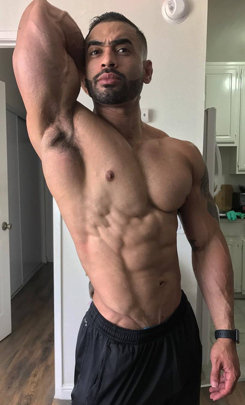 Jamie LeRoyce flexing his abs and obliques at home, looking ripped