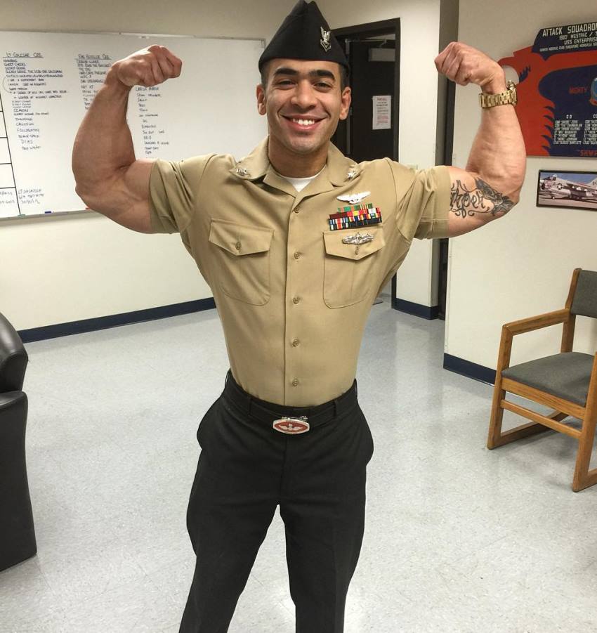 Jamie LeRoyce doing a front double biceps pose in his military uniform