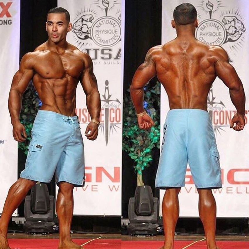Jamie LeRoyce standing on Men's Physique stage, looking aesthetic