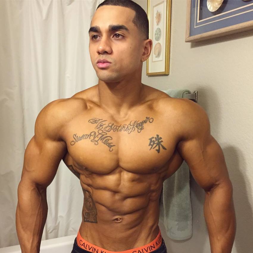 Marvin Moss III in the bathroom, posing for a picture, looking ripped and aesthetic