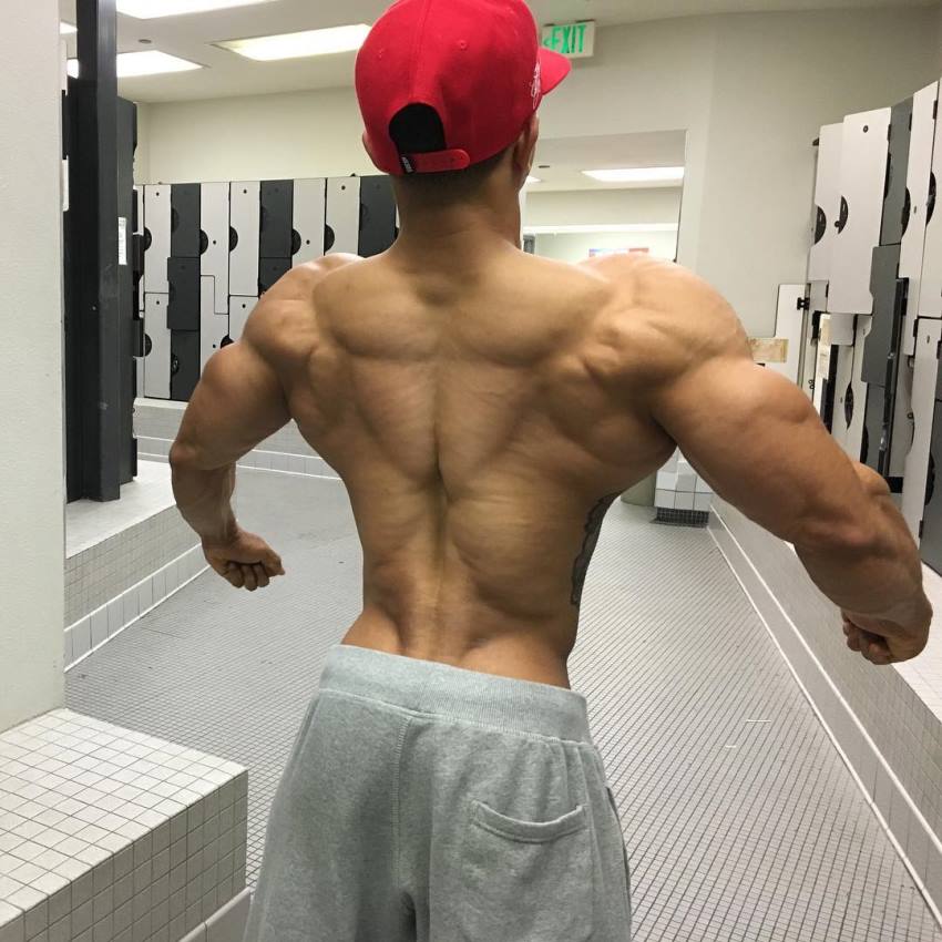 Marvin Moss III flaring his lats and arms wide to show his ripped and muscular back