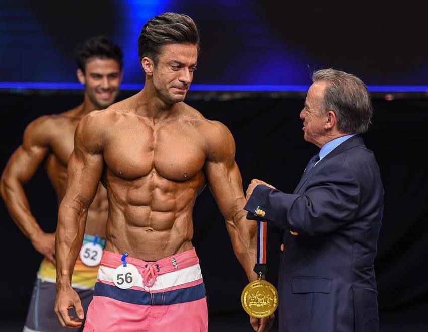 Mohammad Kashanaki crying on the stage as he receives his gold medal