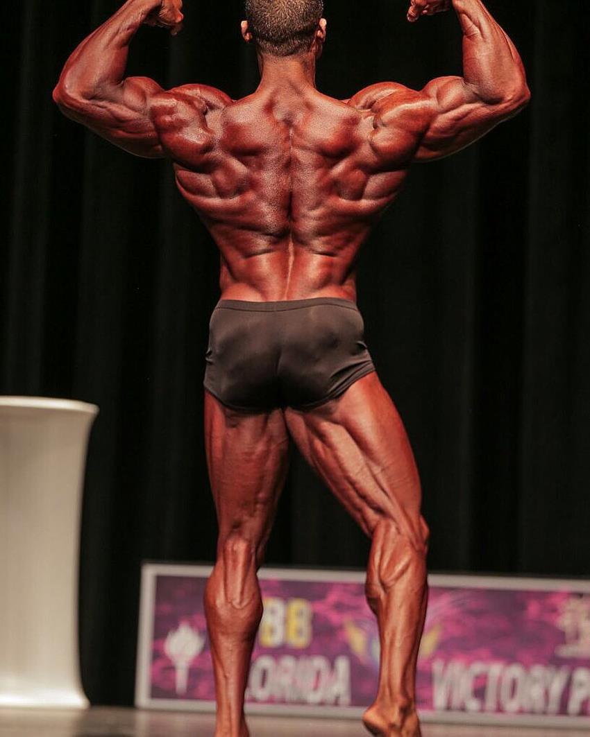 Robert Galva doing a back double biceps pose in a classic physique contest