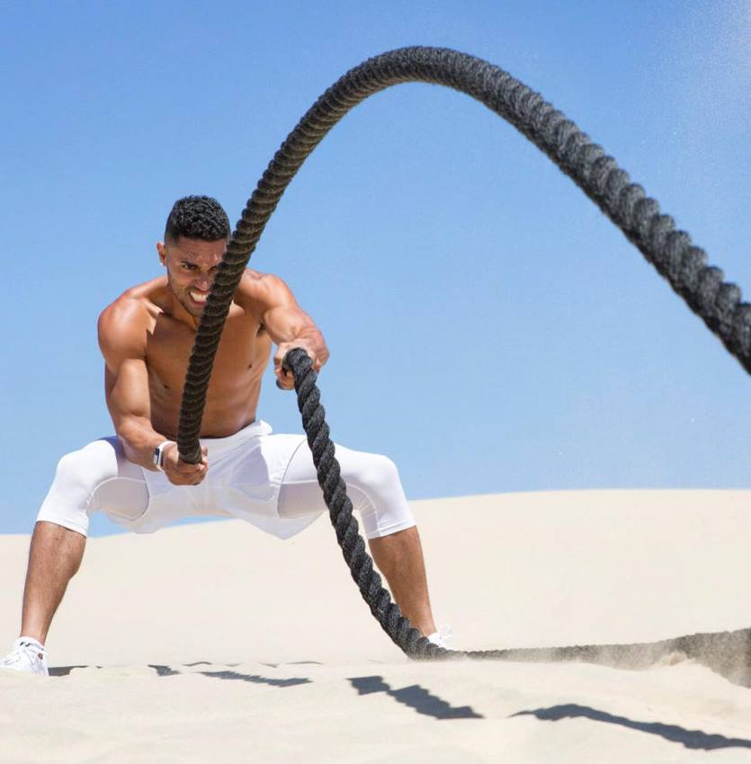 Ryan Tremaine Klarenbach exercising with ropes on the sand