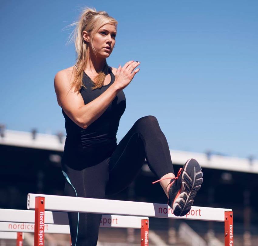 Sara Back jumping over obstructions on the track field