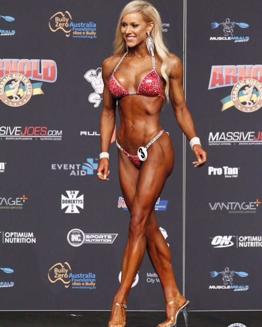 Sara Back walking onto the bikini stage, looking conditioned and aesthetic