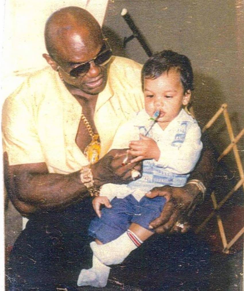 Sergio Oliva Jr when he was a child, sitting in his father's lap