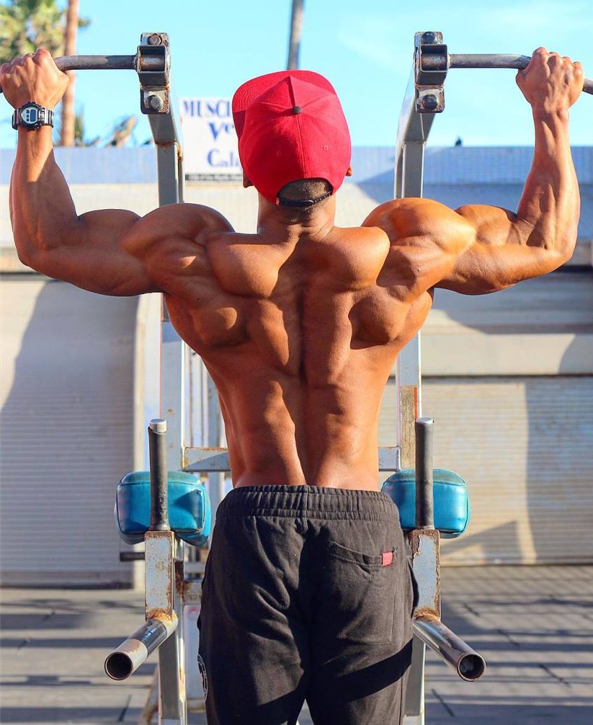 Ahmad DeGuzman doing pull ups, his back looking ripped and muscular