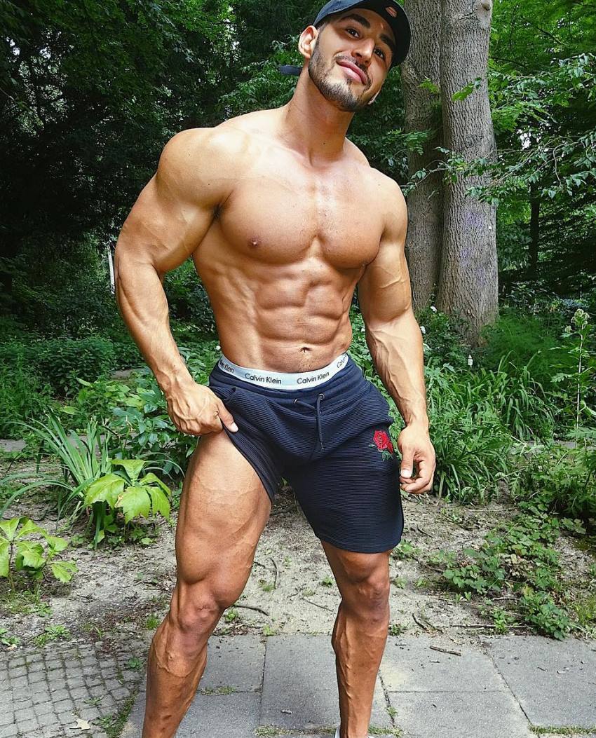 Amin Elkach showing off his abs, arms, chest, and legs