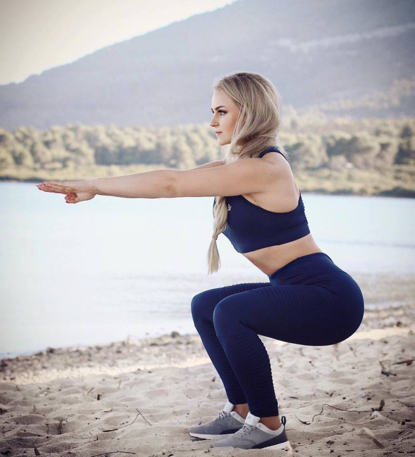 Anna Nystrom squatting by the river