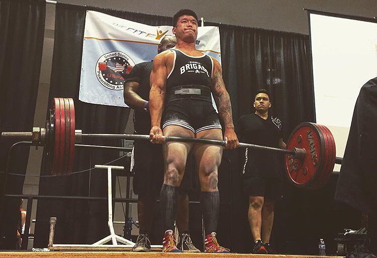 Bart Kwan lifting heavy deadlift in a powerlifting competition
